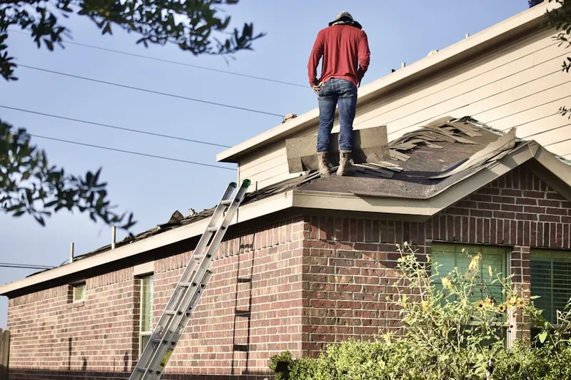 Professional roofer working on a residential roof in Oak Crest